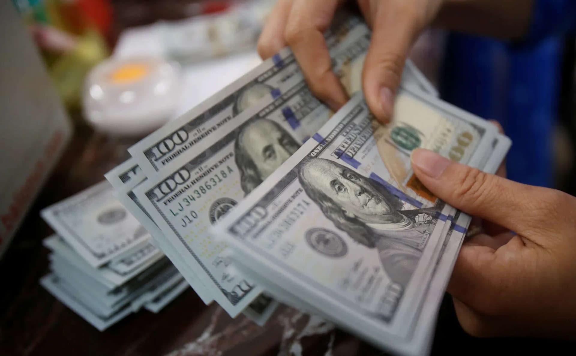 The dollar remained stable ahead of key central bank decisions, including the Federal Reserve's meeting, while the euro shrugged off Fitch's downgrade of France.