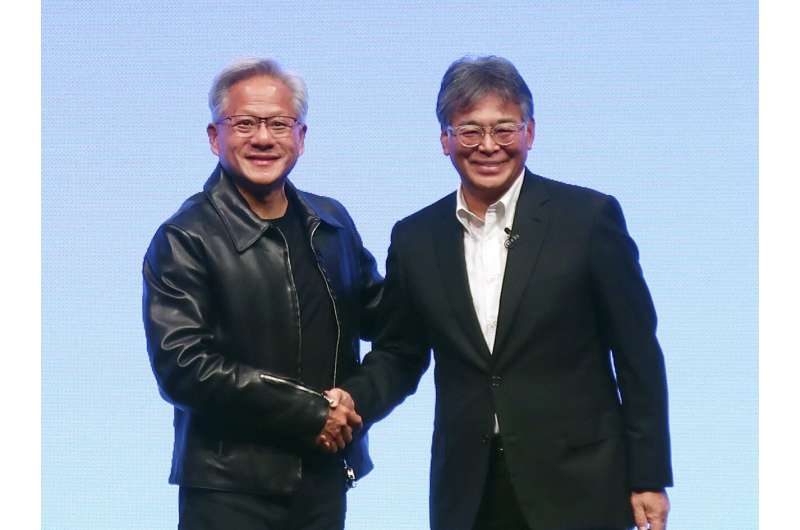Nvidia Chief Executive Jensen Huang, left, and Fujitsu Chief Executive Takahito Tokita shake hands during an announcement in Tokyo Friday, Oct. 3, 2025. Credit: Kyodo News via AP