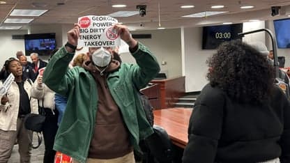 Protestors are escorted out of a Georgia Public Service Commission meeting on Friday, Dec. 19, 2025 in Atlanta. (AP Photo/Jeff Amy)